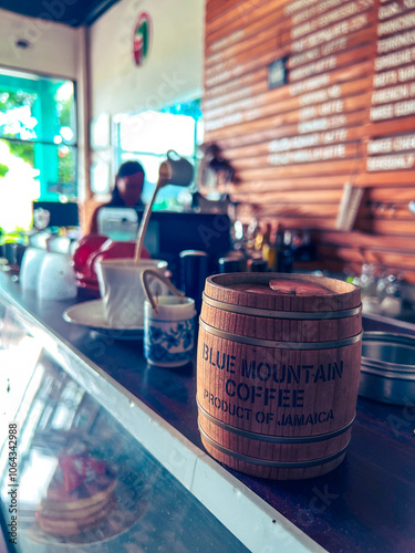 blue mountain coffee and its barista blurred in the background