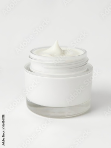 Close up of white beauty cream jar with silver lid isolated on white background, close up, product