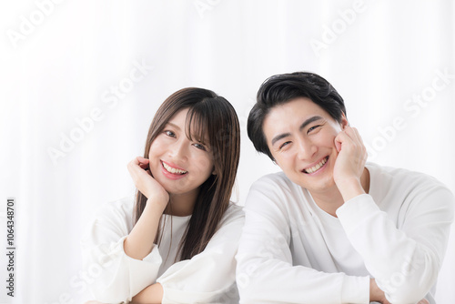 Frontal close-up of a smiling man and woman looking at the camera cheek to cheek in a couple Copy space