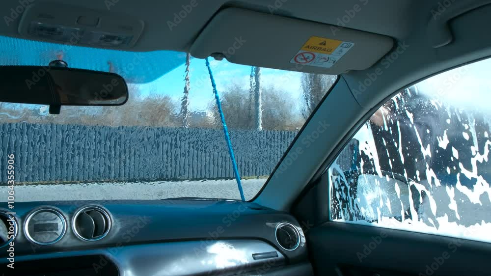 Soap foam on glass during car wash. A view of automobile cleaning at service with soap outdoor. Soap foam on glass during car wash. A view of automobile cleaning at service with soap outdoor.