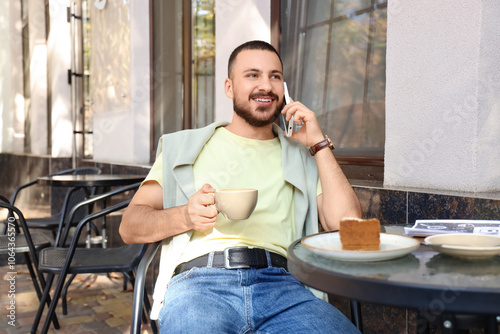 Young man with cappuccino a...