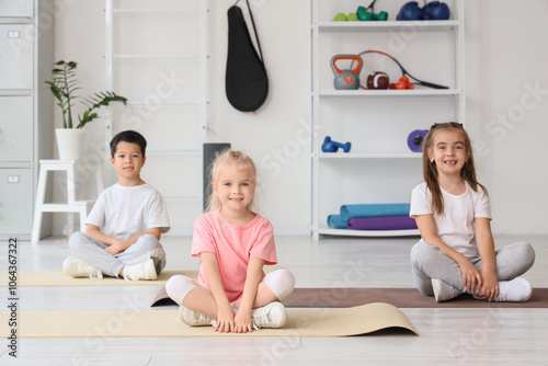 Happy diverse children sitt...