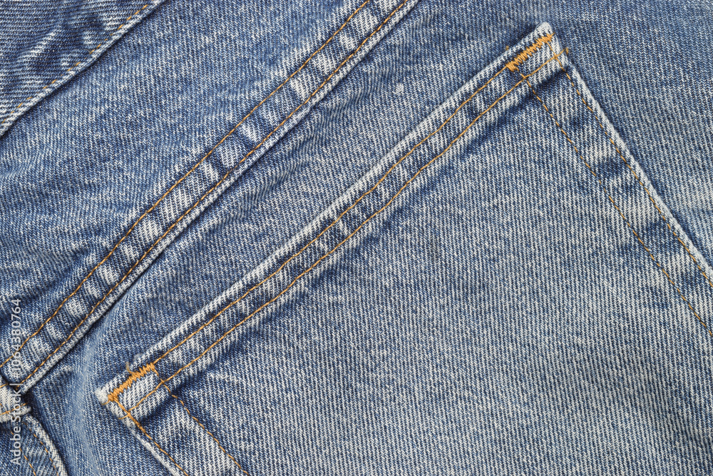 Denim blue jeans fabric background with back pocket Denim blue jeans fabric background with back pocket