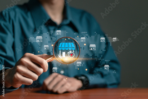 Local marketplace e-commerce concept, local seo strategy, local search optimization, small business and retail. Businessman using magnifying glass focus to local marketplace icon on virtual screen. photo