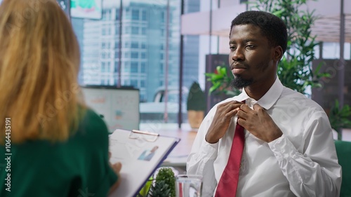 Φωτογραφία Anxious inexperienced job applicant feeling very uncomfortable during interview, being insecure and overwhelmed while he talks about himself and his qualifications with the HR team
