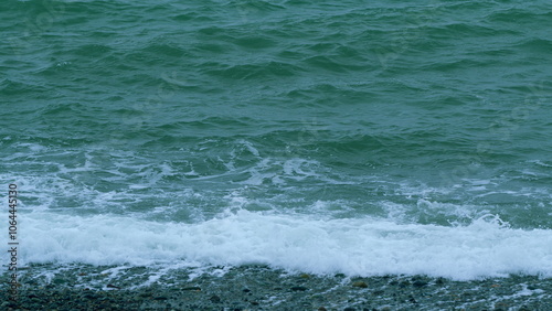 Waves With Seafoam Breaking On Beach. Ocean Great Blue Wave Sea. Slow motion.