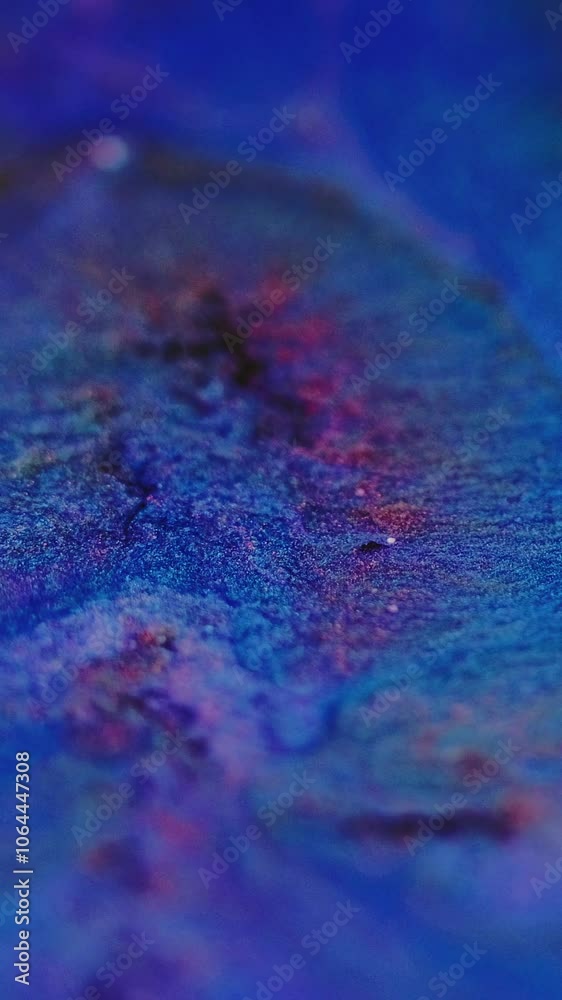 Vertical video. Glitter ink splash. Fluid spill. Defocused blue red color shimmering texture acrylic liquid paint flow motion abstract art background. Vertical video. Glitter ink splash. Fluid spill. Defocused blue red color shimmering texture acrylic liquid paint flow motion abstract art background.