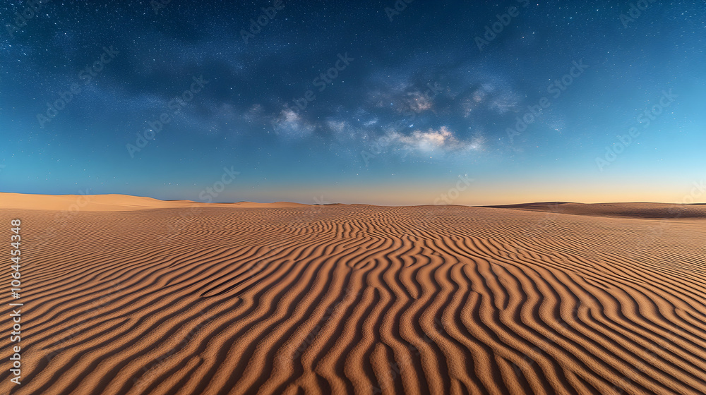 Naklejka premium Starry night sky over a desert landscape with sand dunes.
