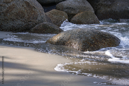 Beautiful soft wave on a rocky beach. Beach sand with soft wave. Summer vacation concept