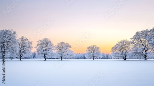 A peaceful winter sunset scene, where the sky transitions from bright orange to deep purple as the sun dips below the horizon. Snow-dusted trees frame the composition, suggesting a tranquil escape.