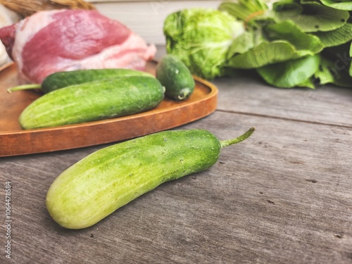 Raw pork and cucumber on wood board