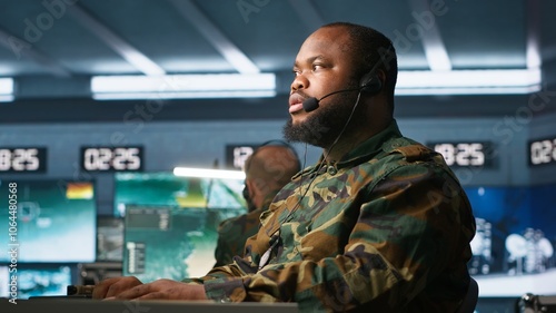 Army telecommunication systems operator providing combat support using gathered information on enemy troops. Military dispatcher managing communications networks in base of operations, camera A