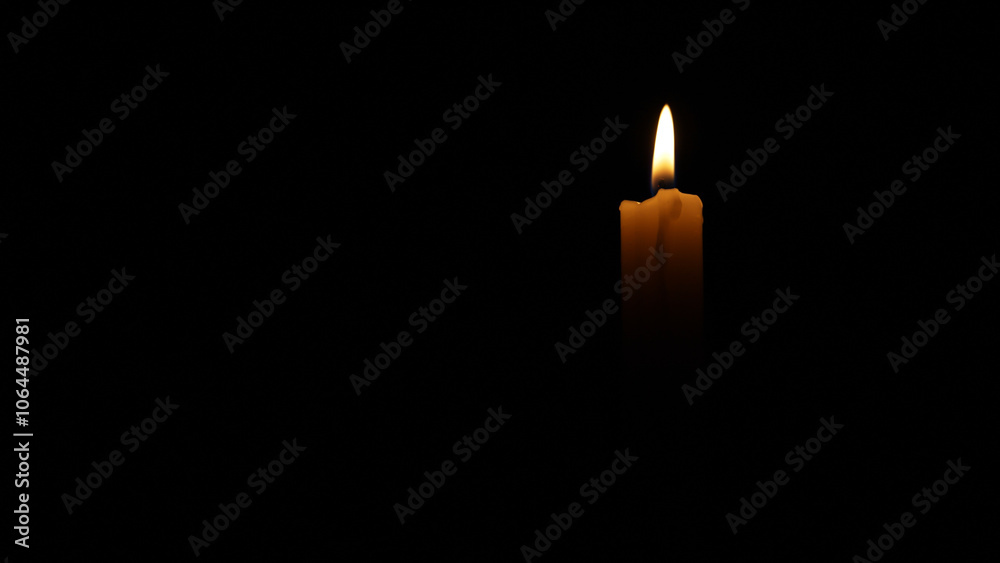 Candlelight flickering in the dark, creating a somber and contemplative atmosphere. Ideal for projects related to remembrance, loss, or spirituality Candlelight flickering in the dark, creating a somber and contemplative atmosphere. Ideal for projects related to remembrance, loss, or spirituality