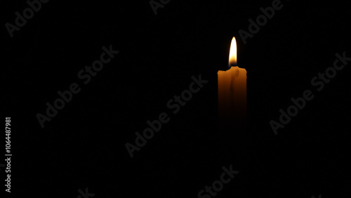 Candlelight flickering in the dark, creating a somber and contemplative atmosphere. Ideal for projects related to remembrance, loss, or spirituality