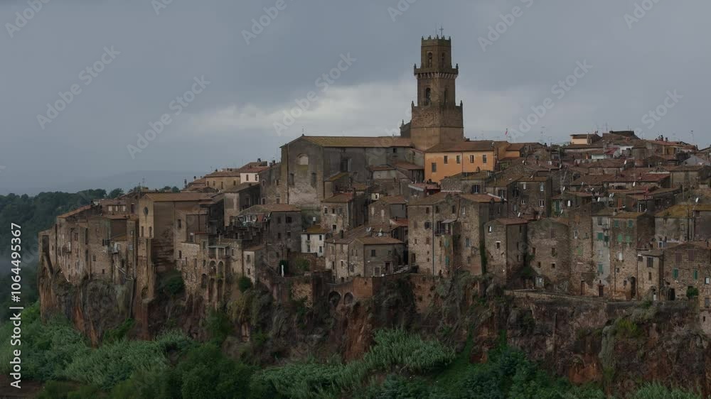 Pitigliano Italy, cliffside medieval town, telephoto drone view, overcast moody weather Pitigliano Italy, cliffside medieval town, telephoto drone view, overcast moody weather