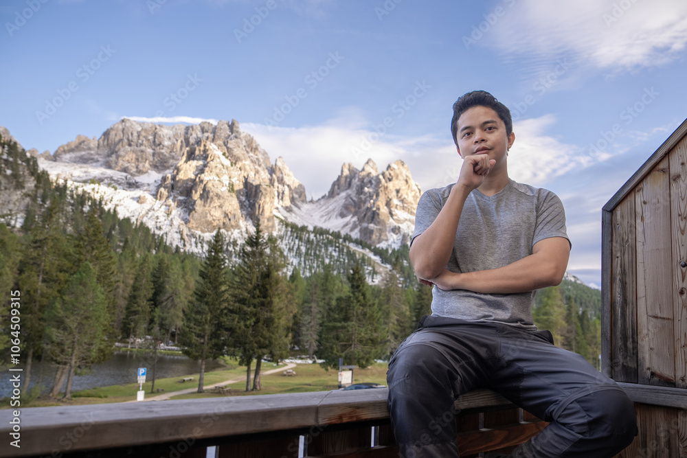 Man enjoy view of mountain peak from Lake Antorno (Lago di Antorno) located in Dolomites, Italy. Man enjoy view of mountain peak from Lake Antorno (Lago di Antorno) located in Dolomites, Italy.