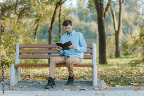 Casual reader on a park bench surrounded by fall foliage and tranquility