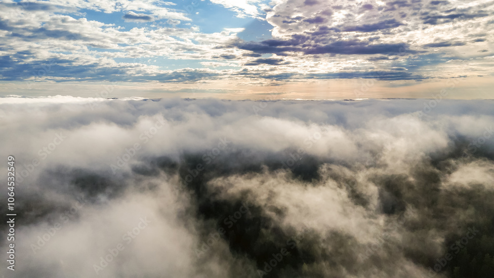 Obraz premium Flying above the clouds at dawn in autumn