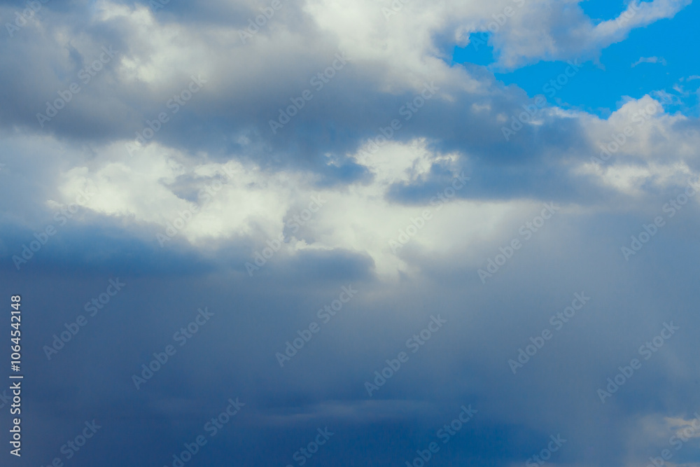 Obraz premium Cumulus clouds. Beautiful dark blue dramatic sky. Copy space for lettering. Few clouds against a blue sky on a sunny day.