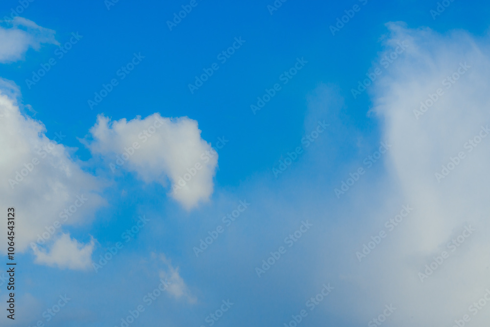 Obraz premium Cumulus clouds. Beautiful dark blue dramatic sky. Copy space for lettering. Few clouds against a blue sky on a sunny day.