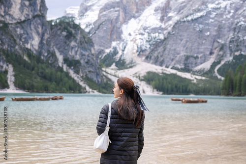 Woman enjoy view of lake Braies or Lago di Braies in Dolomites, Italy.