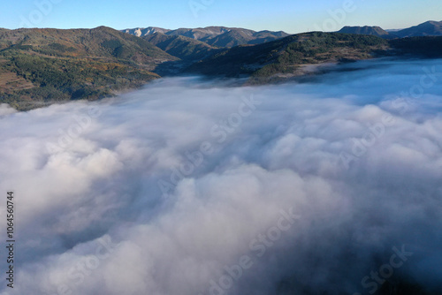 Aerial view of autumn morning mist and clouds in the valley