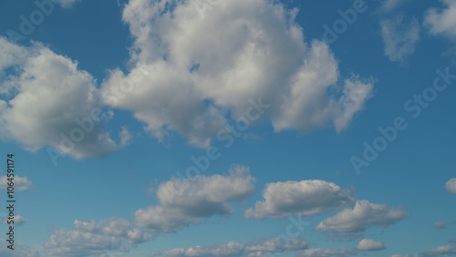 Puffy Fluffy White Clouds. Cumulus Cloud Cloudscape. White Fluffy Clouds Slowly Float Through Blue Daytime Sky.