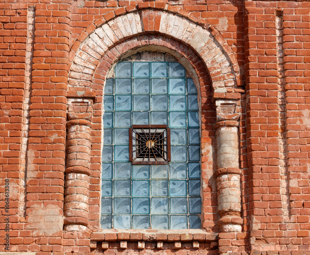 Fototapeta premium A window with a blue glass pane and a metal grate
