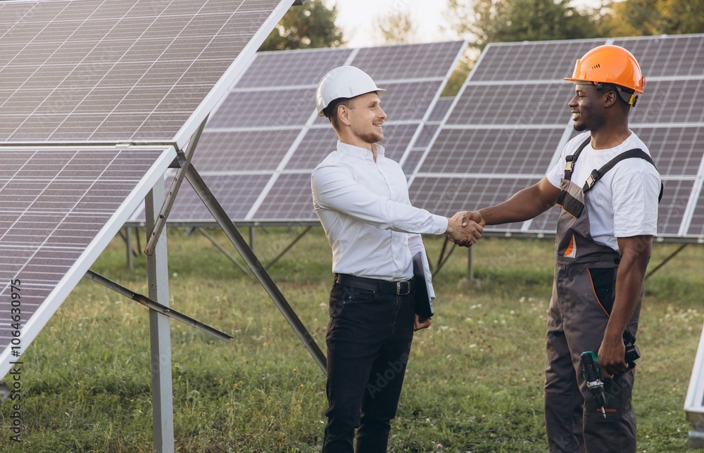 Engineers Shaking Hands at Solar Panel Installation Site Engineers Shaking Hands at Solar Panel Installation Site