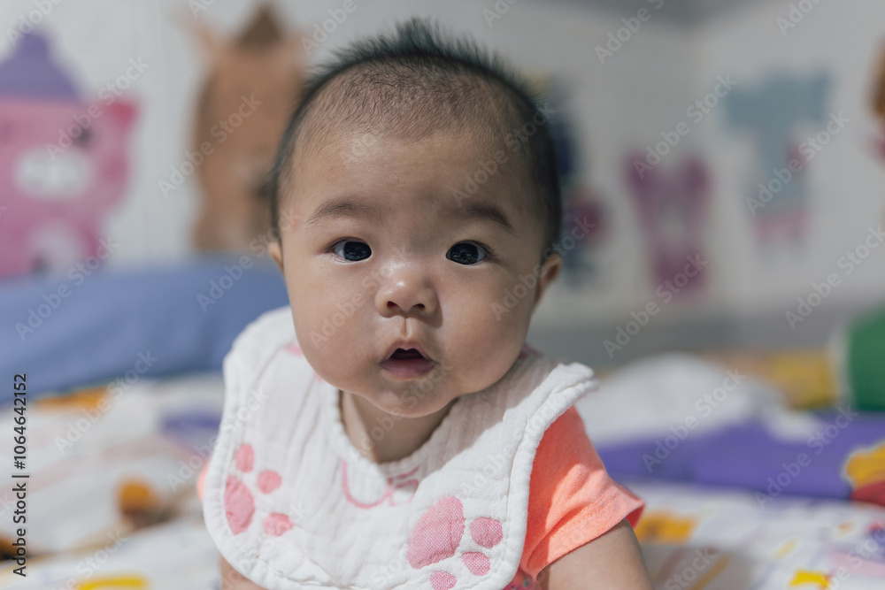 Happy Smiling face of 4 month old Asian Chinese baby girl during lying on bed. Happy Newborn child relaxing in bed Happy Smiling face of 4 month old Asian Chinese baby girl during lying on bed. Happy Newborn child relaxing in bed