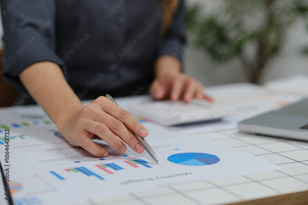 A woman is looking at a graph on a table A woman is looking at a graph on a table