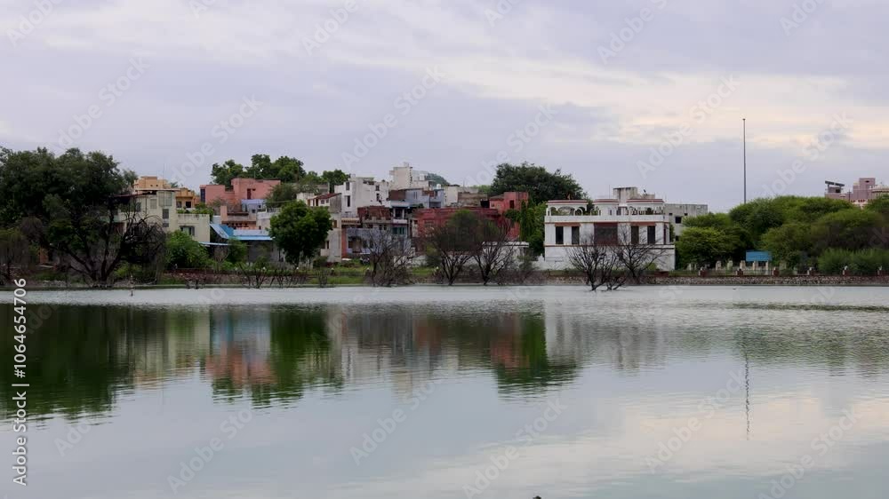 Serene Lake with city View and water Reflections Under Bright Sky at morning Serene Lake with city View and water Reflections Under Bright Sky at morning