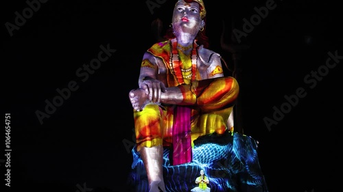 Statue of Hindu God Lord Shiva as holy goddess shakti in Meditation Posture with laser light effect photo