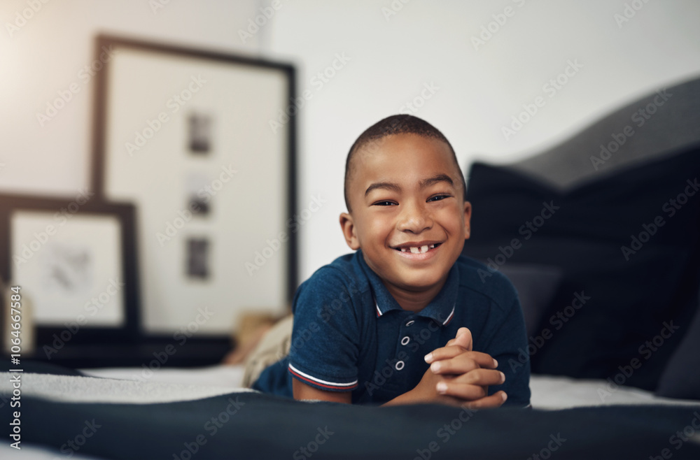 Happy child, confident and portrait in bed in home to relax for peace, growth and youth development in apartment. Face, smile or African boy resting for calm break and comfort on mattress in Tunisia Happy child, confident and portrait in bed in home to relax for peace, growth and youth development in apartment. Face, smile or African boy resting for calm break and comfort on mattress in Tunisia