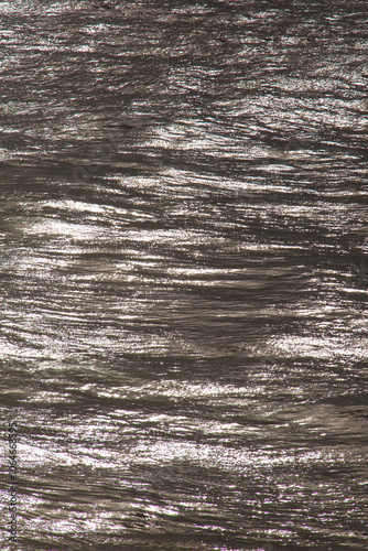 Light streaked ocean swell, grey and silver colours. 