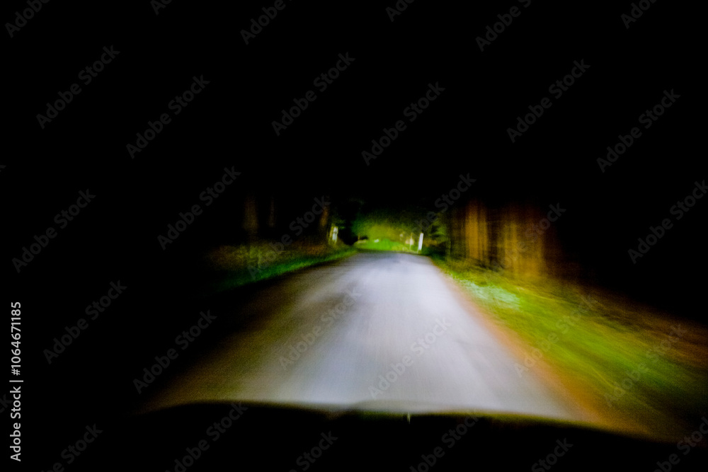 Headlights illuminating a rural road Headlights illuminating a rural road