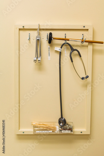 Close up of a reflex hammer, stethoscope and other medical tools. photo