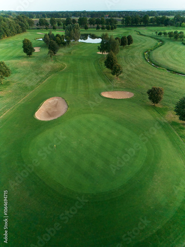 Aerial image of Expansive Golf Green with Dual Bunkers and Water View in summer