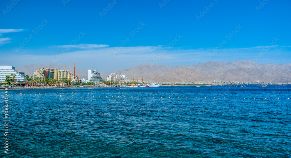 Fototapeta premium sea scape resort hotels luxury reach district waterfront UAE country panorama landscape with water foreground and desert mountains background summer travel destination view