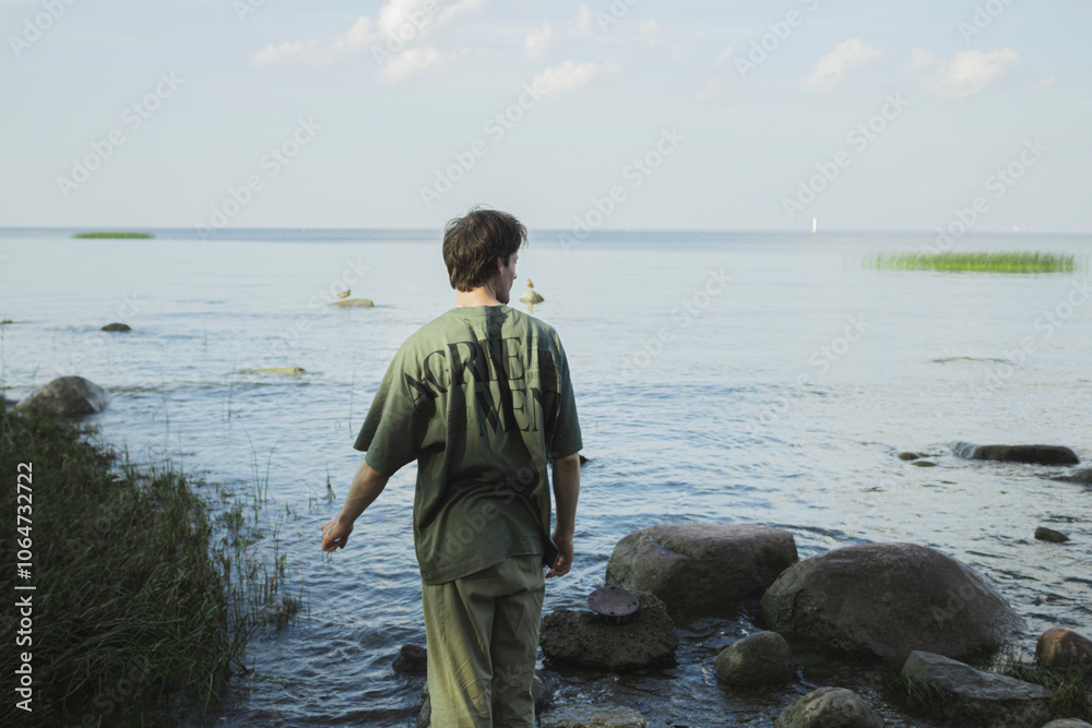 Man standing back and looking at the sea. Man standing back and looking at the sea.