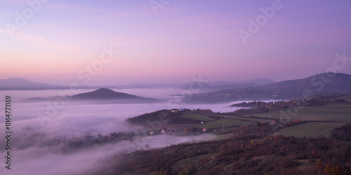 Hills in foggy evening. Radobyl hill in Czech Midland/ Ceske Stredohori, Czech republic