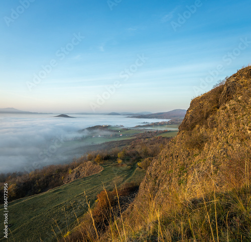 Hills in foggy evening. Radobyl hill in Czech Midland/ Ceske Stredohori, Czech republic