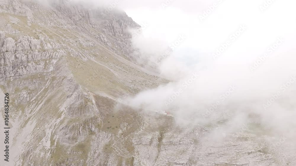 Misty aerial overview of Mount Tymfi peaks, surrounded by dense clouds in a mystical landscape Misty aerial overview of Mount Tymfi peaks, surrounded by dense clouds in a mystical landscape