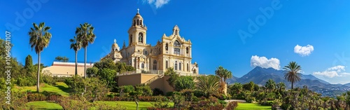 A breathtaking view of La Virgen de África Basilica in Ceuta against a clear blue sky and lush gardens