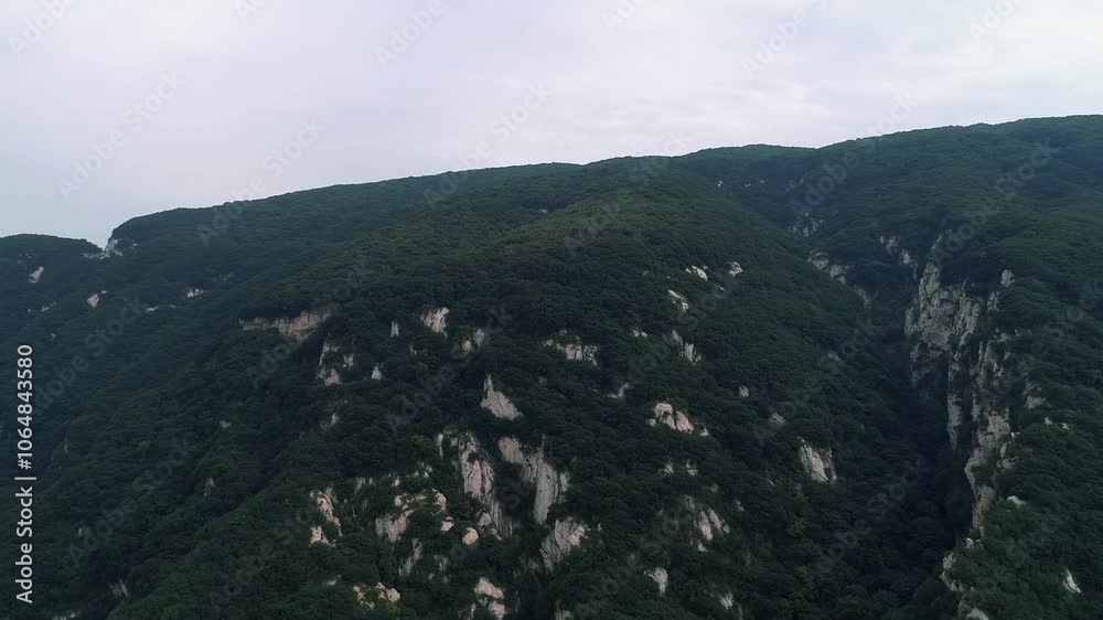 Aerial drone view of Dengfeng color Cableway near Shaolin temple in China. Cable cars run through forest near the Pagoda Forest and Shaolin Temple. Songshan Mountain in Dengfeng City, Henan Province. Aerial drone view of Dengfeng color Cableway near Shaolin temple in China. Cable cars run through forest near the Pagoda Forest and Shaolin Temple. Songshan Mountain in Dengfeng City, Henan Province.