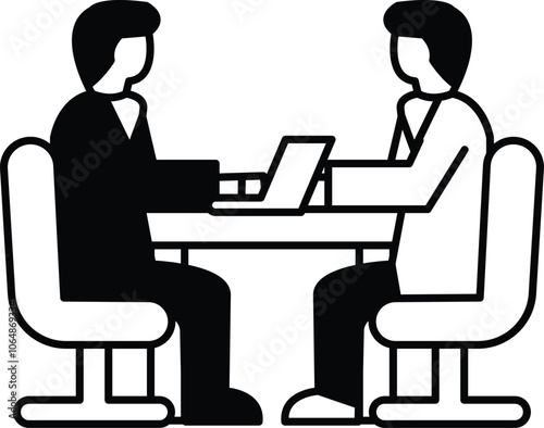 Two men sitting at a table with a laptop in front of them