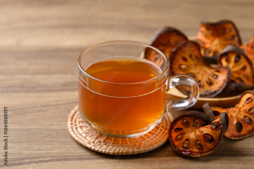 Bael fruit herbal drink in cup glass on wooden background, Healthy drink Bael fruit herbal drink in cup glass on wooden background, Healthy drink