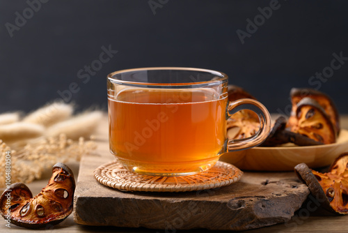 Bael fruit herbal drink in cup glass on wooden background, Healthy drink