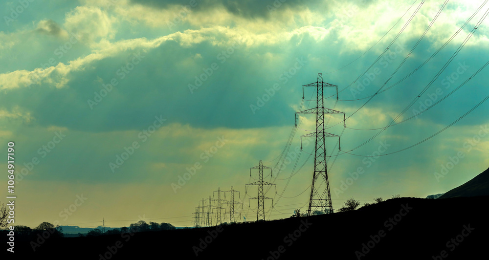 Electricity Pylons Tower Above And Stretch Across The Landscape Of The United Kingdom Electricity Pylons Tower Above And Stretch Across The Landscape Of The United Kingdom