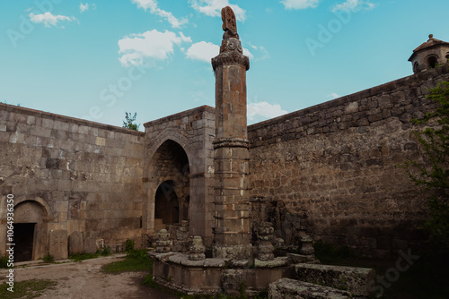 Exploring the ancient architecture of Tatev Monastery in Armenia under a clear blue sky